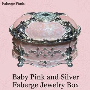 Baby pink Faberge type jewelry box.This is a beautiful pink opens style box. It has Swarovski crystal and is large domed liid 5x3x3.2.5”.