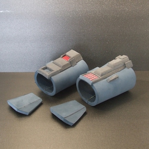 May include: Two blue foam arm pieces with black and gray details, and two smaller blue foam pieces. The arm pieces have a grid pattern and red accents.