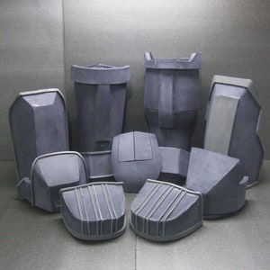 May include: A set of 10 gray foam pieces for crafting or cosplay. The pieces are various shapes and sizes, including rectangular, square, and curved.