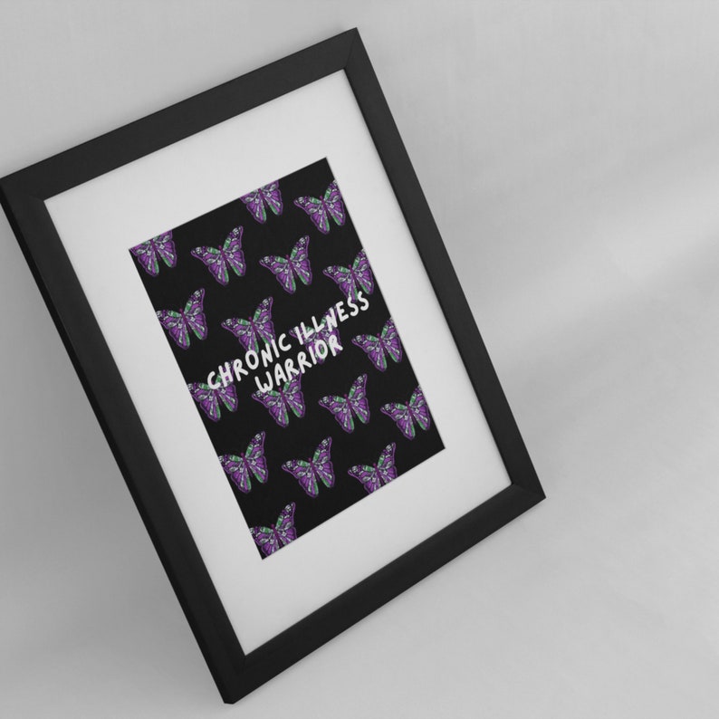 May include: A black framed print with a black background and a pattern of purple and green butterflies. The text "CHRONIC ILLNESS WARRIOR" is written in white in the center of the print.