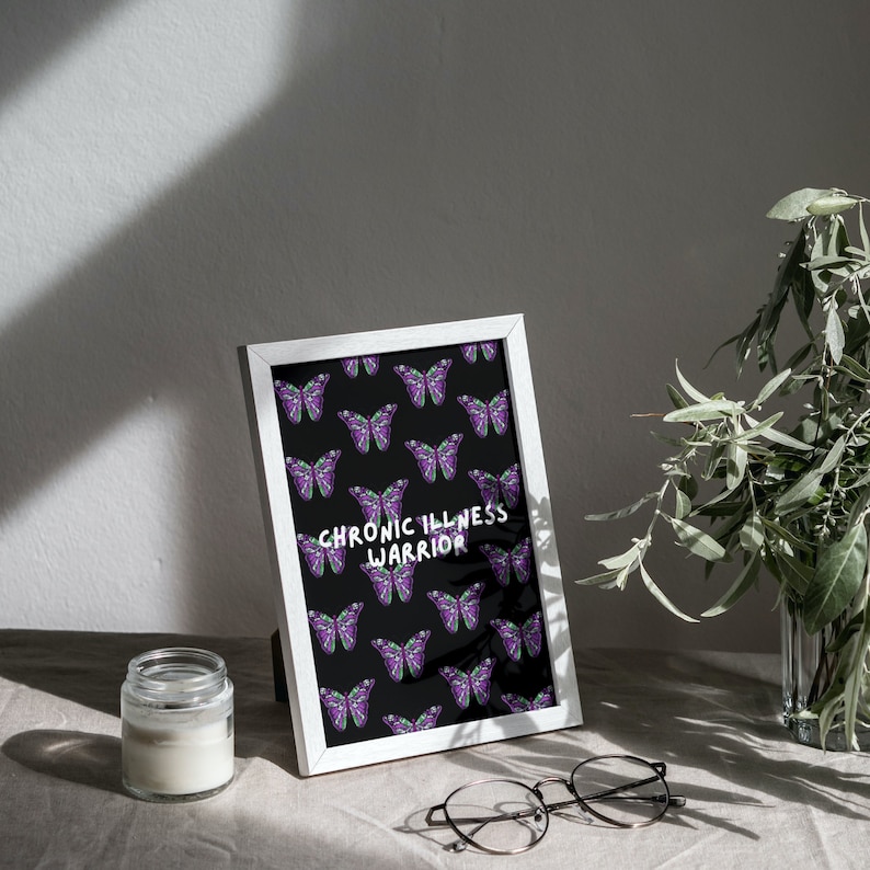 May include: White framed print with a black background and a repeating pattern of purple butterflies. The text "CHRONIC ILLNESS WARRIOR" is printed in white in the center of the print.