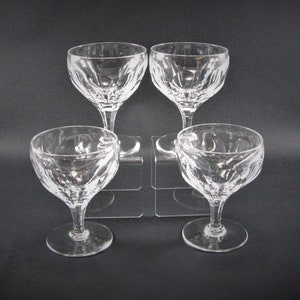 May include: Set of four clear glass stemmed dessert dishes with a cut glass design.
