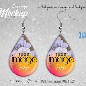 May include: Mockup of a pair of teardrop-shaped earrings with a floral design and a gradient background. The earrings are yellow, orange, pink, and purple. The text "your image here" is printed on the earrings. The text "Edit With: Canva PSD (SMART OBJECT) PNG FILES" is printed below the earrings.