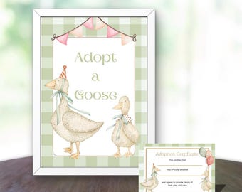 May include: A framed print with the text "Adopt a Goose" and illustrations of two geese. The print has a green and white gingham background and is decorated with pink pennants. A smaller adoption certificate is also visible.