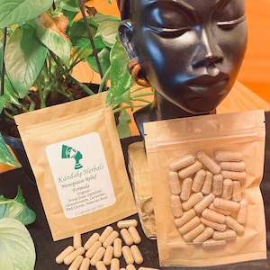 May include: A brown paper bag with the text "Kandake Herbals Menopause Relief Formula" and a list of ingredients. The bag contains brown capsules.