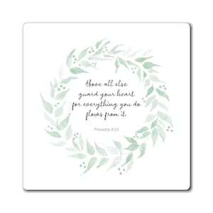 May include: A watercolor illustration of a green leafy wreath with the quote "Above all else guard your heart for everything you do flows from it." and the scripture reference "Proverbs 4:23".