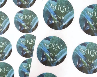 May include: A sheet of white sticker paper with multiple round stickers featuring a sage green leaf design. The stickers have the text "Sage Mystic Boutique" printed on them.
