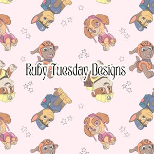 May include: A pink background with a repeating pattern of cartoon dogs from the Paw Patrol TV show. The dogs are wearing their signature uniforms and helmets. There are also small white stars scattered throughout the pattern. The text "Ruby Tuesday Designs" is in the centre of the image.