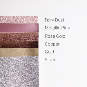May include: A stack of six different colored faux leather sheets. The colors are: fairy dust, metallic pink, rose gold, copper, gold, and silver.