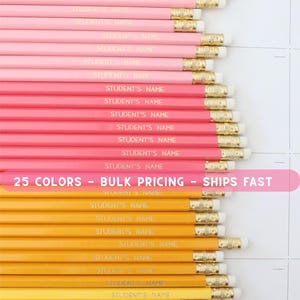 May include: A collection of pencils in shades of yellow, orange, and pink, arranged in rows. Each pencil is printed with "STUDENT'S NAME" in gold lettering. The image also includes text that reads "25 COLORS - BULK PRICING - SHIPS FAST".