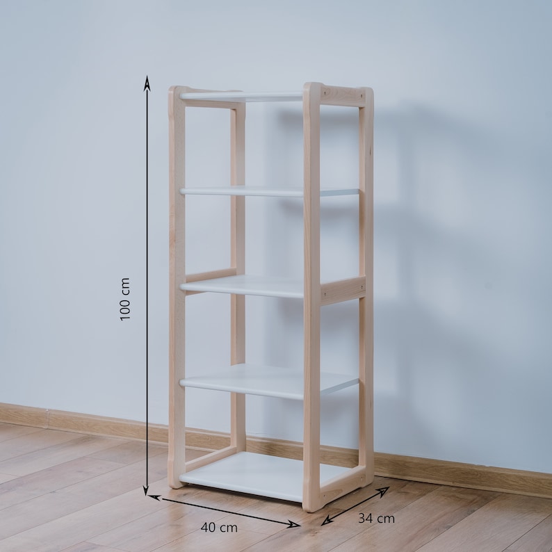 May include: A white shelf unit with four shelves and a natural wood frame. The shelf unit is 40 inches wide, 34 inches deep, and 100 inches tall.