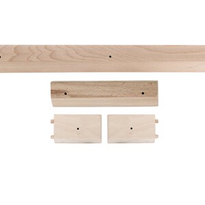 May include: A set of three wooden shelves, each with a simple design and a natural wood finish. The shelves are ideal for displaying small items or organising a workspace.
