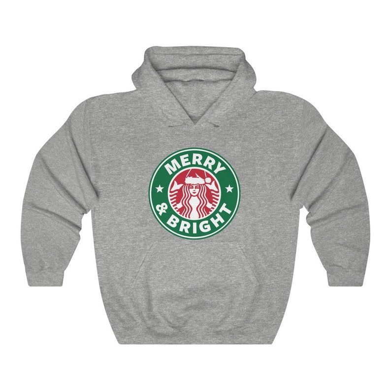 May include: A gray hooded sweatshirt with a green and white logo that says "Merry & Bright" with a stylized image of a woman wearing a Santa hat.