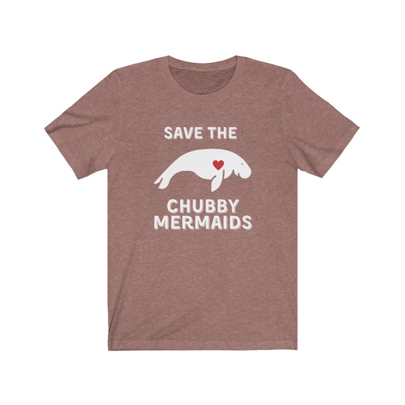 May include: A heather grey t-shirt with the text "Save the Chubby Mermaids" in white. A white silhouette of a manatee with a red heart is in the center of the shirt.