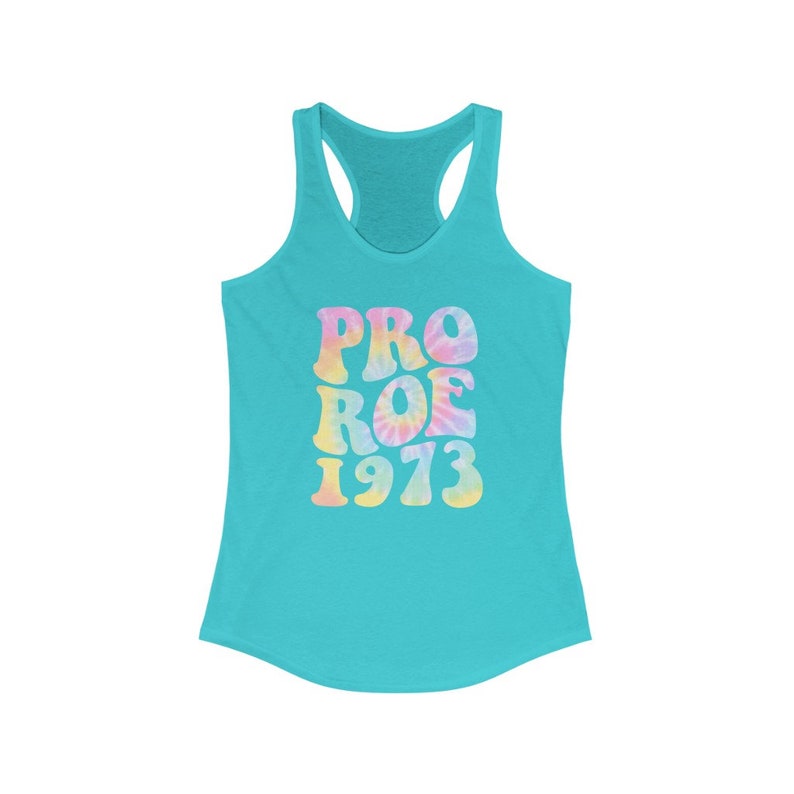 May include: A turquoise racerback tank top with the words "PRO ROE 1973" in a tie-dye design. The text is in pastel colors, including pink, yellow, and blue. The tank top has a scoop neck and a racerback design.