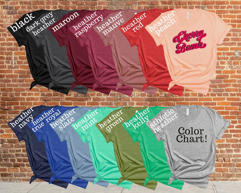 May include: A collection of various colored t-shirts, including black, dark grey, maroon, and heather red. One shirt features the text "Cherry Bomb" in a retro font. A color chart is also displayed.