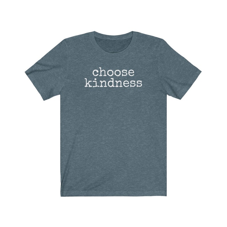 May include: A short-sleeved, heathered teal t-shirt with the words "choose kindness" printed in white block letters across the chest. The shirt has a crew neck and a relaxed fit, suitable for casual wear.