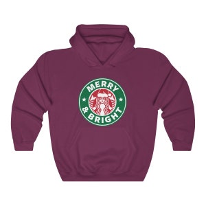 May include: A maroon hoodie with a green and white logo that says "Merry & Bright" with a stylized image of a woman wearing a Santa hat.