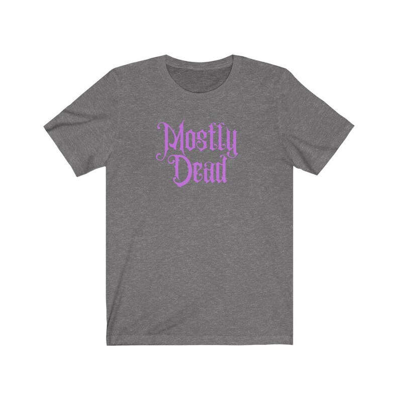 May include: A heather grey t-shirt with a purple graphic that says "Mostly Dead" in a gothic font.
