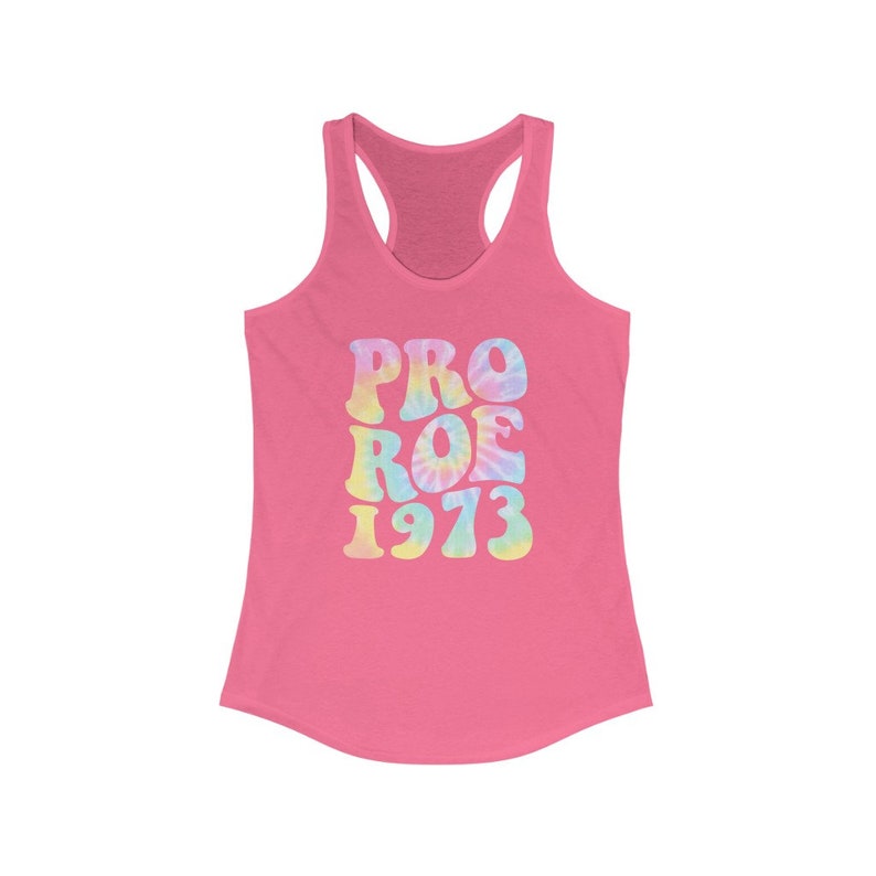 May include: Pink racerback tank top with the words "PRO ROE 1973" in a tie-dye design. The text is in a retro font, with pastel colors of blue, yellow, and pink. The tank top has a scoop neck and a racerback design.