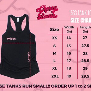 May include: Black tank top with a racerback design. The image includes a size chart for the "1533 Tank Top" with measurements in inches. The text "Cherry Bomb" is displayed at the top. The text "These tanks run small! Order up 1 to 2 sizes!" is at the bottom.