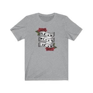 May include: A heather grey t-shirt featuring a graphic of a banner with the text "Cats and Tats" and red roses.