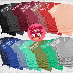 Peut inclure: Une vari&eacute;t&eacute; de t-shirts de diff&eacute;rentes couleurs et styles, y compris noir, gris fonc&eacute; chin&eacute;, bordeaux chin&eacute;, framboise chin&eacute;, mauve chin&eacute;, rouge chin&eacute;, p&ecirc;che chin&eacute;, bleu marine chin&eacute;, bleu royal chin&eacute;, ardoise chin&eacute;, menthe chin&eacute;, vert chin&eacute;, kelly chin&eacute; et gris chin&eacute; athl&eacute;tique. Les chemises sont toutes pli&eacute;es et dispos&eacute;es en rang&eacute;e. Le texte "Cherry Bomb" est visible au centre de l'image.