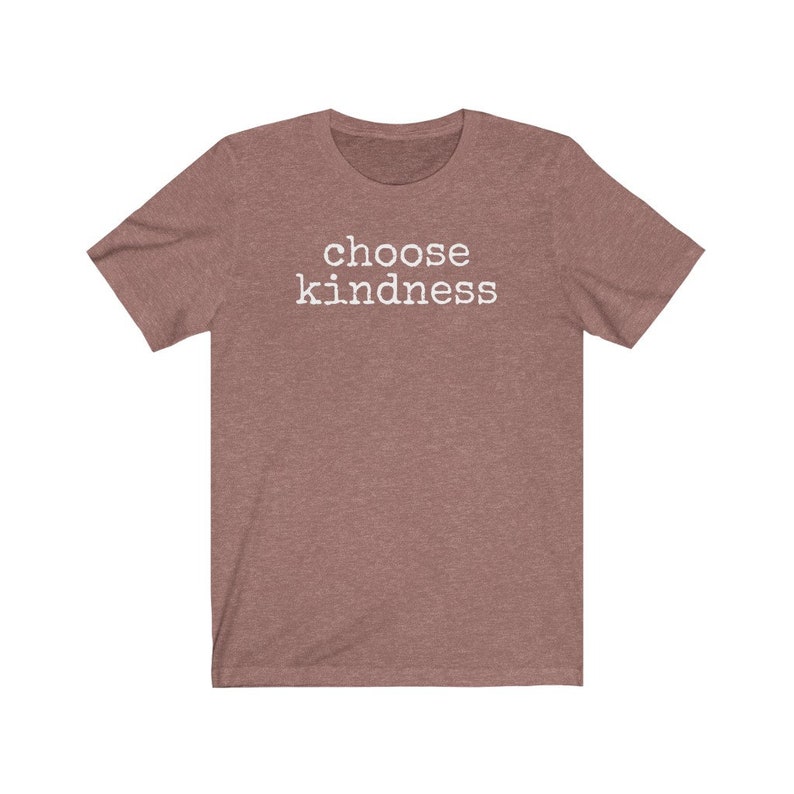 May include: A short-sleeved, heathered mauve t-shirt with the words "choose kindness" printed in white block letters across the chest. The shirt has a crew neck and a casual fit, suitable for everyday wear.