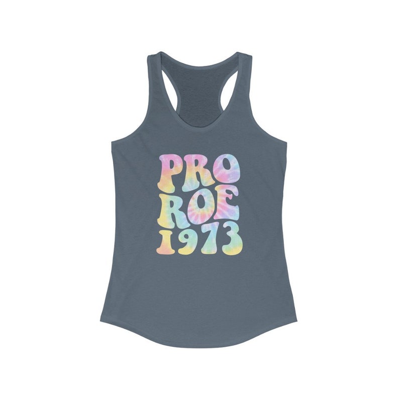 May include: A slate blue racerback tank top with the words "PRO ROE 1973" in a tie-dye design. The text is in a retro font with pastel colors of pink, yellow, and blue.