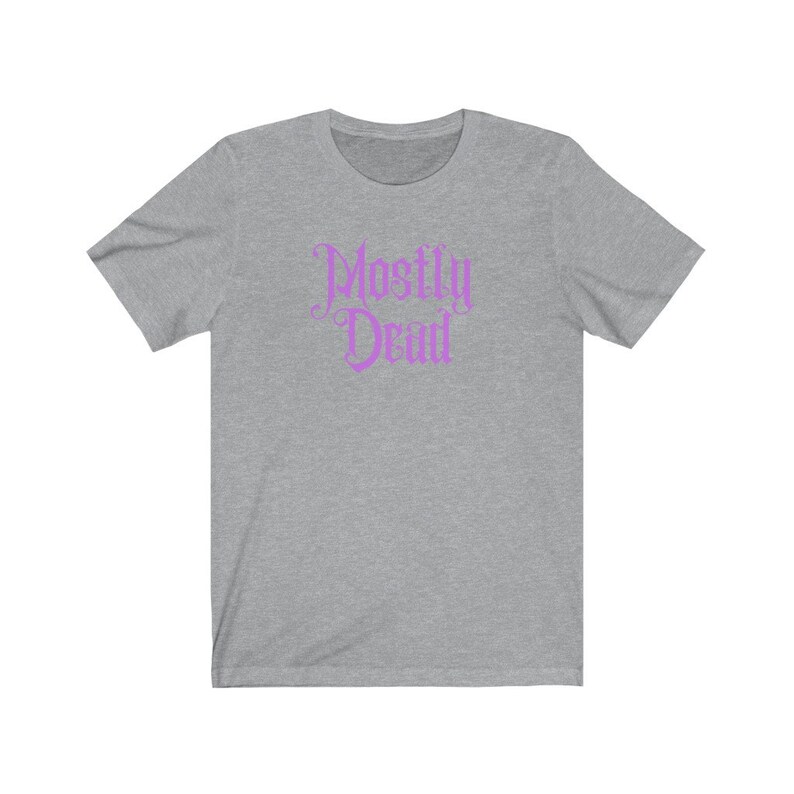 May include: A heather gray t-shirt with a pink graphic that says "Mostly Dead" in a gothic font.