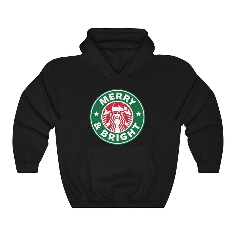 May include: Black hooded sweatshirt with a green and white logo that says "Merry & Bright" with a stylized image of a woman wearing a Santa hat.