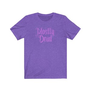 May include: Purple short-sleeved t-shirt with the text "Mostly Dead" in pink.