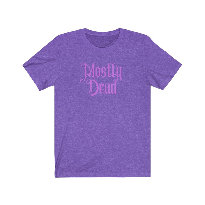 May include: Purple short-sleeved t-shirt with the text "Mostly Dead" in pink.