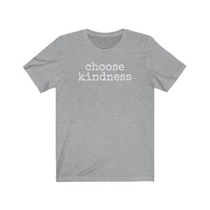May include: A heather gray t-shirt with the words "choose kindness" printed in white across the chest. The shirt has short sleeves and a crew neck.