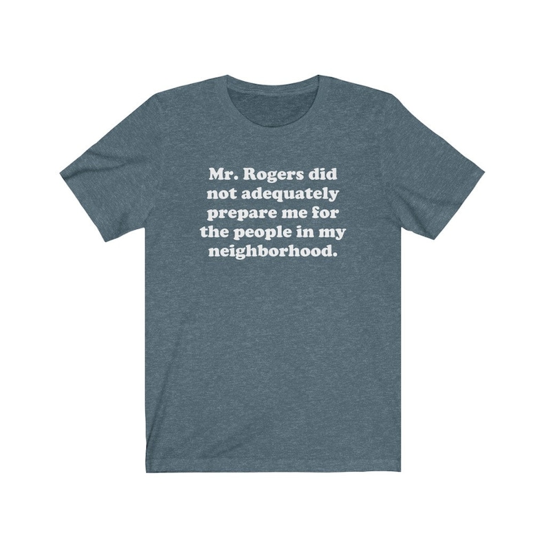 Puede incluir: Una camiseta azul oscuro con el texto "Mr. Rogers no me prepar&oacute; adecuadamente para la gente de mi vecindario."