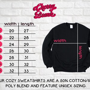 May include: Size chart for a black sweatshirt with measurements in inches for width and length. The chart shows sizes from S to 4XL. The text "Cherry Bomb" is at the top of the chart. The text "OUR COZY SWEATSHIRTS ARE A 50% COTTON/50% POLY BLEND AND FEATURE UNISEX SIZING." is at the bottom of the chart.
