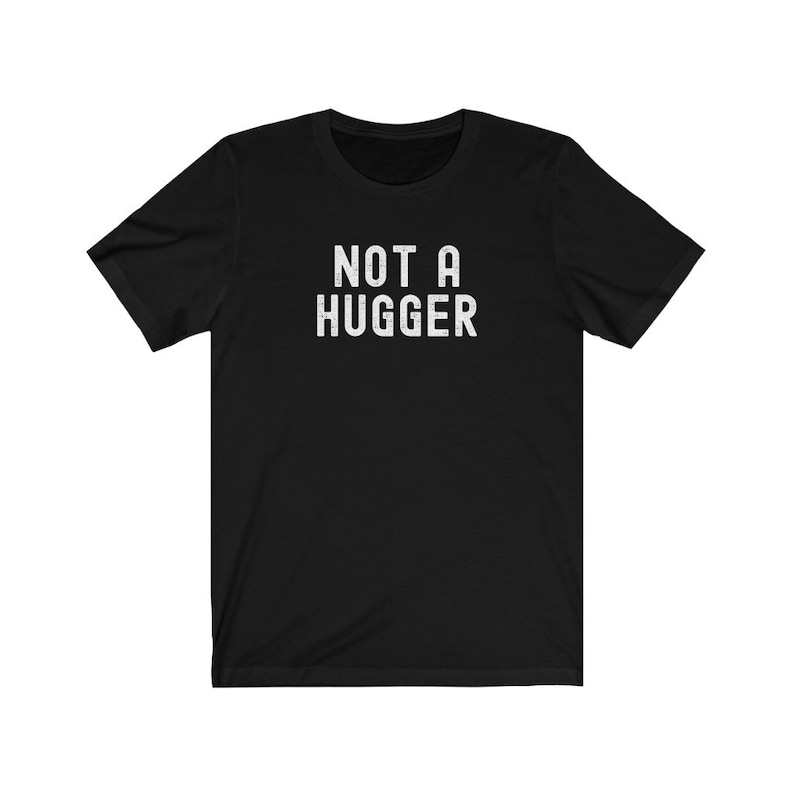 May include: Black short-sleeved t-shirt with the text "NOT A HUGGER" in white.