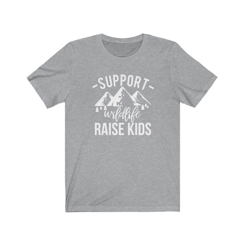 May include: Gray t-shirt with white text that reads "Support wildlife raise kids" with a graphic of mountains and trees.