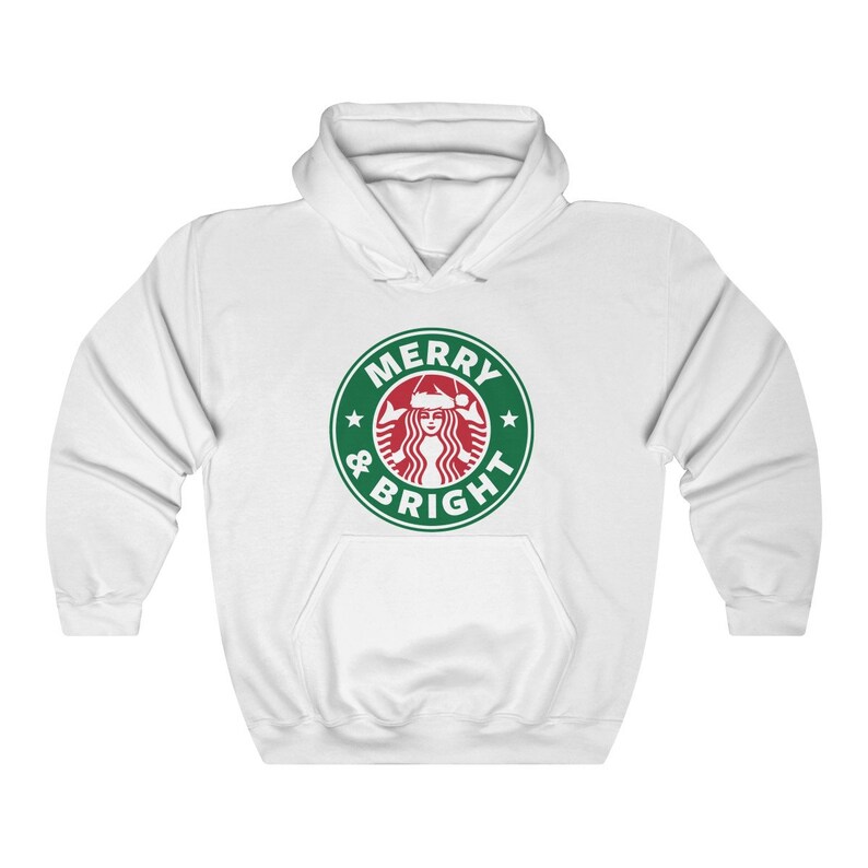 May include: White hoodie with a green and red logo that says "Merry & Bright" with a stylized image of a woman wearing a Santa hat.