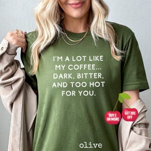 May include: A green t-shirt with the text "I'm a lot like my coffee... dark, bitter, and too hot for you."  The shirt has a cherry graphic with the text "Buy 2 or more" and "Get 30% off".