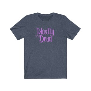 May include: A dark blue t-shirt with a purple graphic that says "Mostly Dead" in a gothic font.