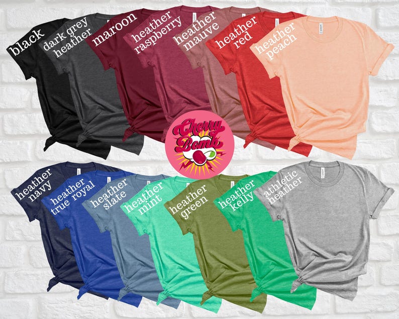 May include: A collection of various colored t-shirts, including black, dark grey heather, maroon, heather raspberry, heather mauve, heather red, and heather peach. Additional colors are heather navy, heather true royal, heather slate, heather mint, heather green, heather kelly, and athletic heather.