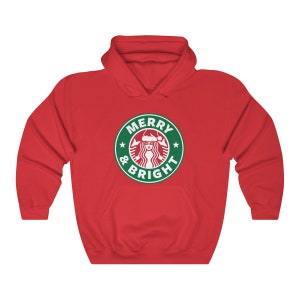 May include: Red hooded sweatshirt with a green and white logo that says "Merry & Bright" with a stylized image of a woman wearing a Santa hat.