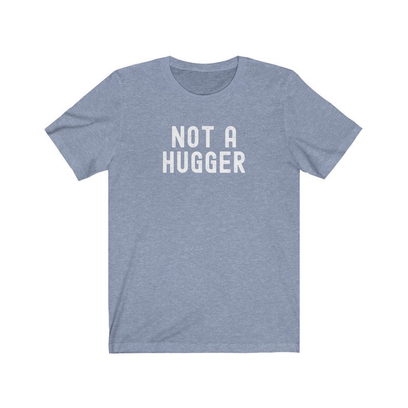 May include: A light blue t-shirt with the text "NOT A HUGGER" printed in white.