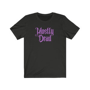 May include: Black t-shirt with a purple "Mostly Dead" graphic in a gothic font.
