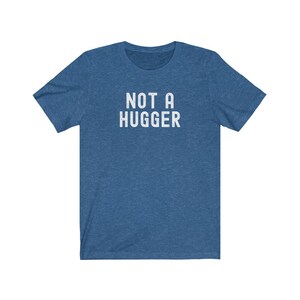 May include: A blue t-shirt with the text "NOT A HUGGER" printed in white.