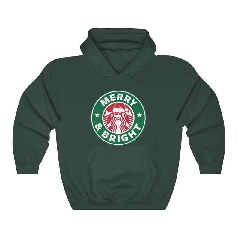 May include: A dark green hoodie with a white graphic of a Starbucks logo with a Santa hat on the mermaid and the text "Merry & Bright".