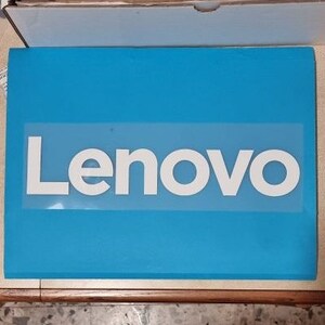 May include: A close-up of a blue laptop case with the word "Lenovo" printed in white on the front.