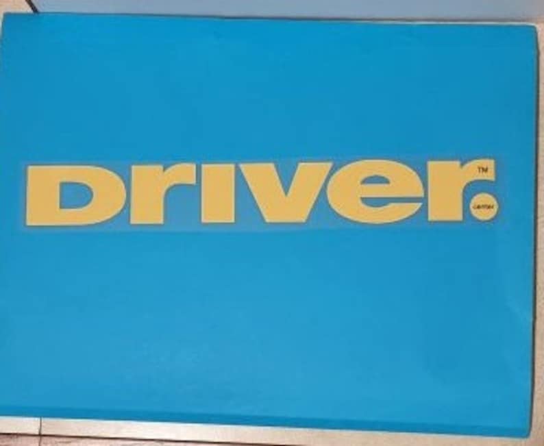 May include: A blue storage box with the word "DRIVER" in yellow letters on the front.