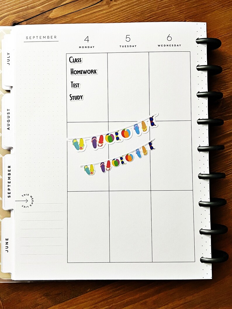May include: A planner page showing the month of September. The page is divided into days, Monday to Wednesday, with the words "Class," "Homework," "Test," and "Study." Two strings of colourful flip-flop and beach ball stickers are displayed.